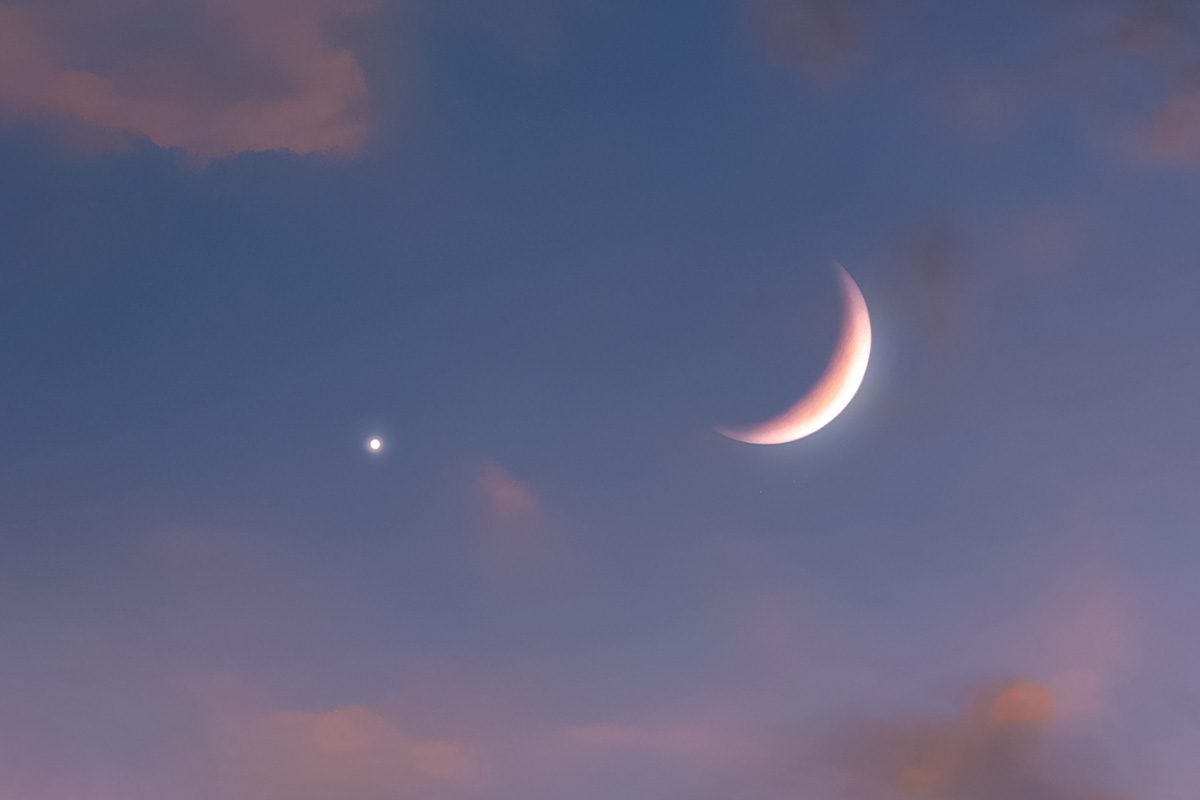 Conjunction of crescent Moon and a star or planet. Credit: Nazarii Neshcherenskyi / Getty Images