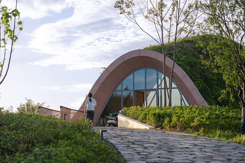 MVRDV perches arched, earth-covered timber pavilion among the hills of chengdu, china