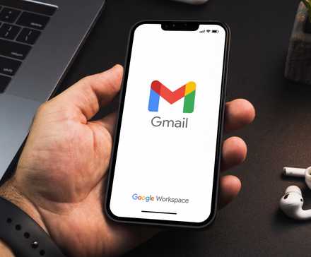 Person holding a phone with Gmail open on it