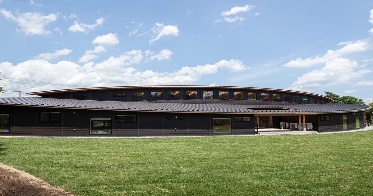 twin leaf-shaped roofs unfold atop nursery school by NIKKEN SEKKEI in japan