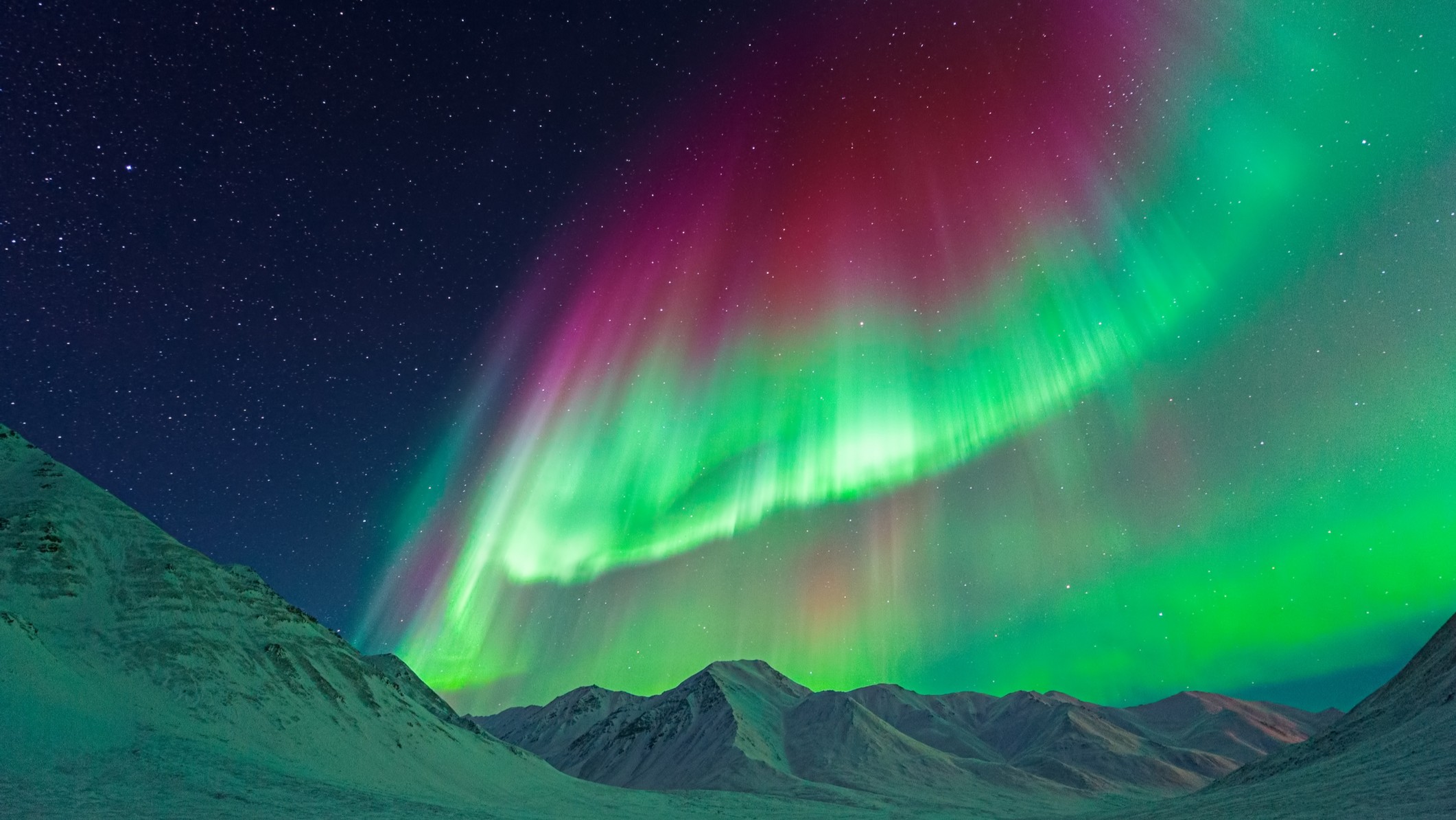Gigantic Aurora borealis (Northern Lights) above mountains near Atigun Pass, Dalton Highway, Alaska, USA