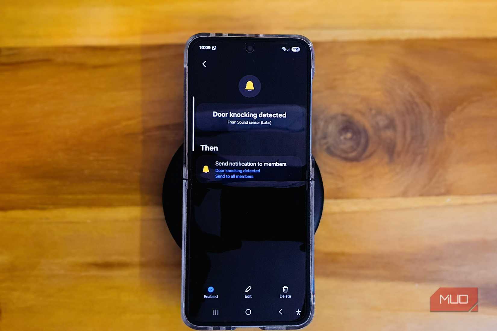 Samsung Galaxy Z Flip 6 kep on a Wooden table with a keyboard on the edge