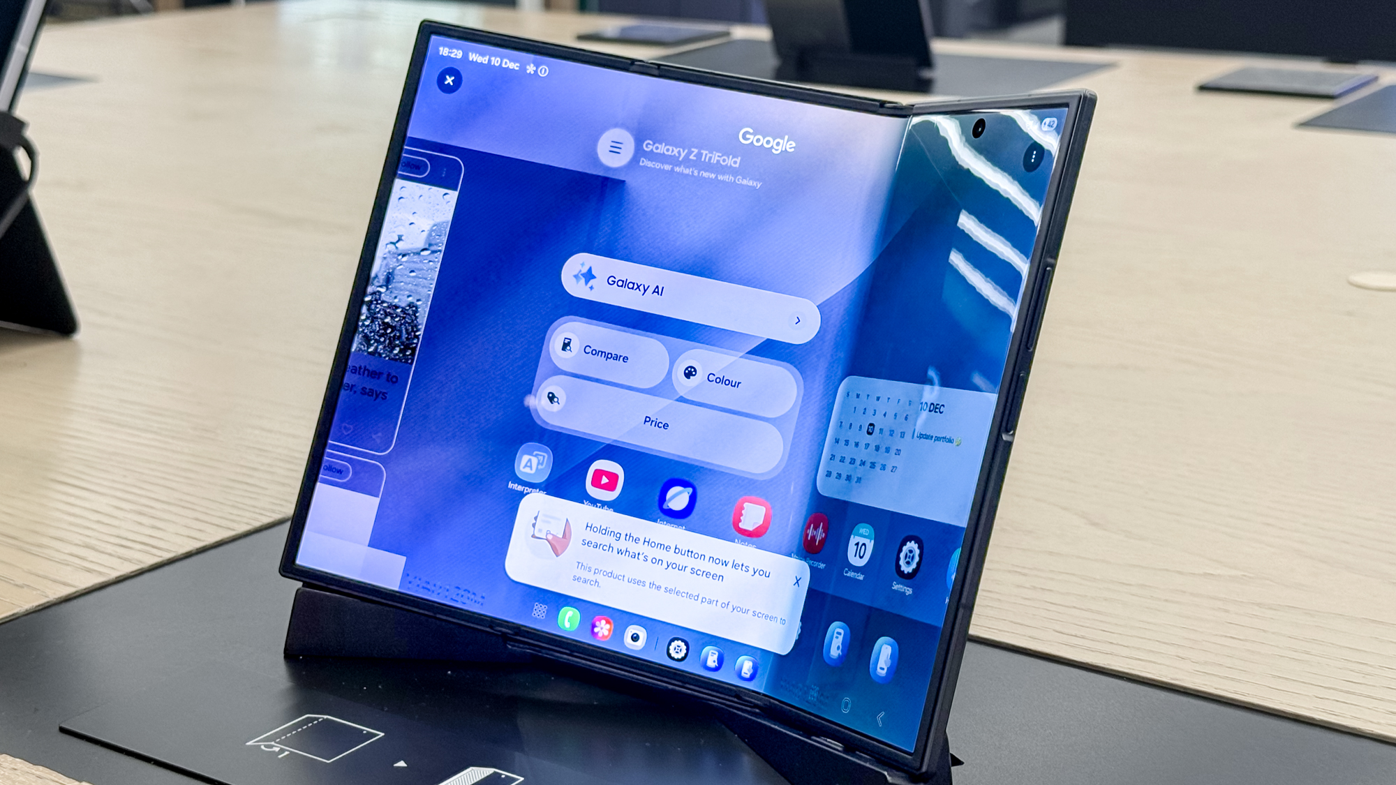 Samsung Galaxy Z TriFold partly unfolded on a stand