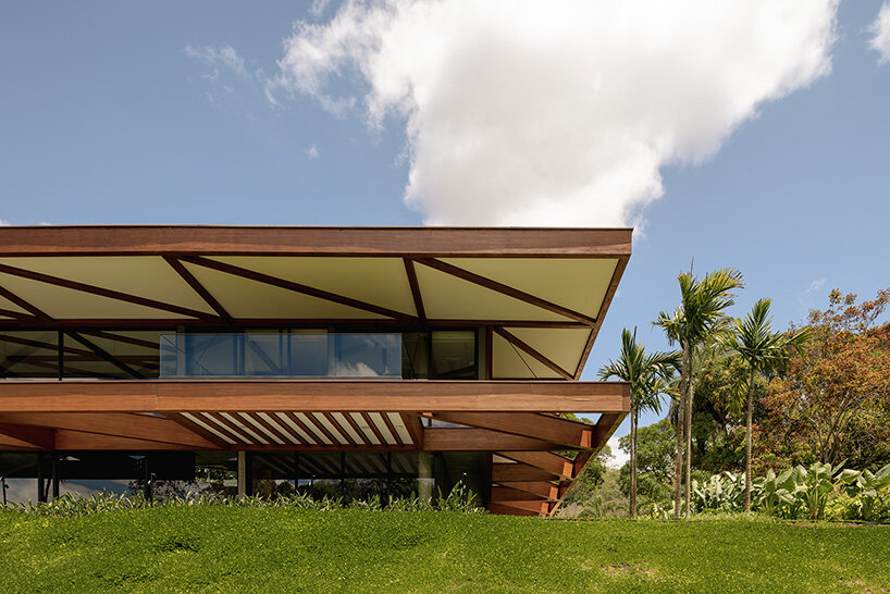TETRO's lakeside residence in brazil vanishes into the horizon beneath triangular timber roof
