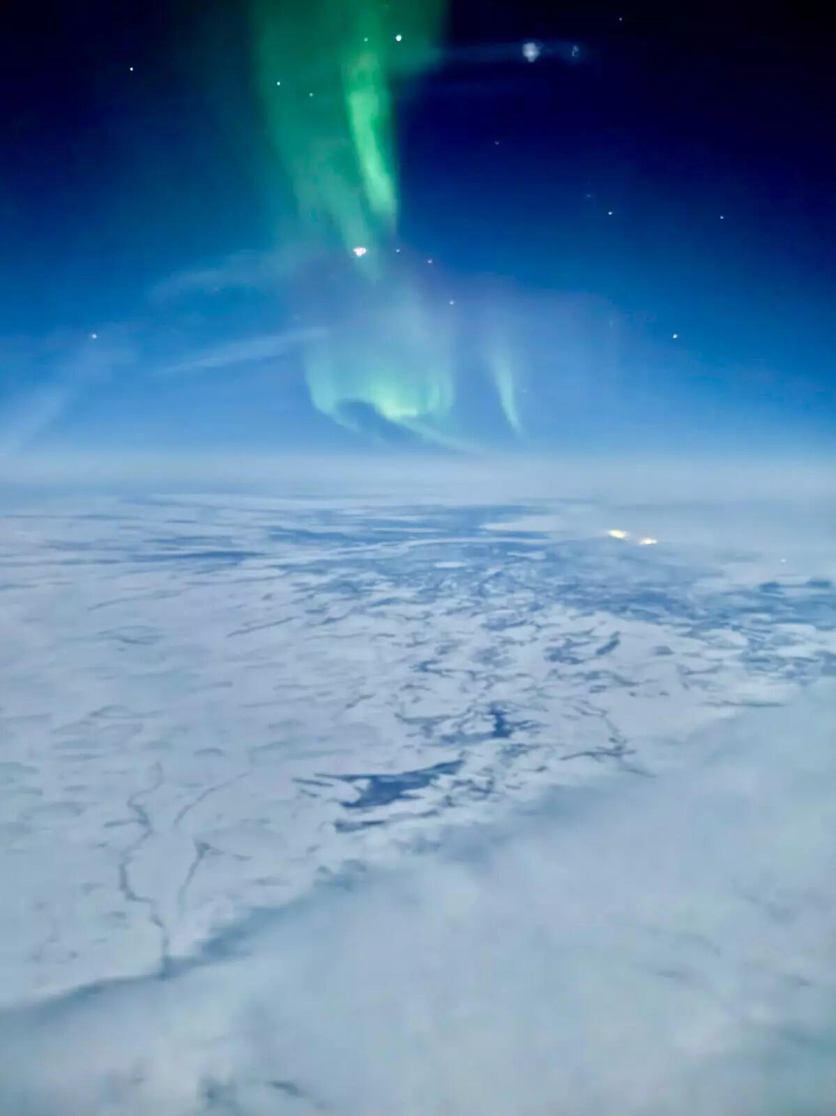 These images capture the northern lights as seen from an SFO–Qatar flight.