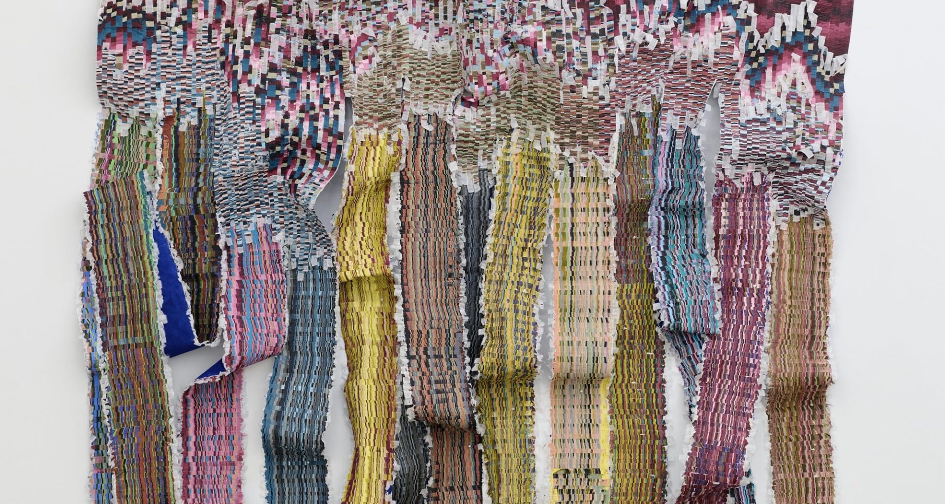 A large woven wall hanging by Kenny Nguyen made from strips of silk fabric