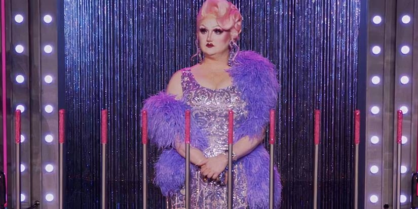 Hormona Lisa standing in front of the dunk tank levers in RuPaul's Drag Race season 17. 