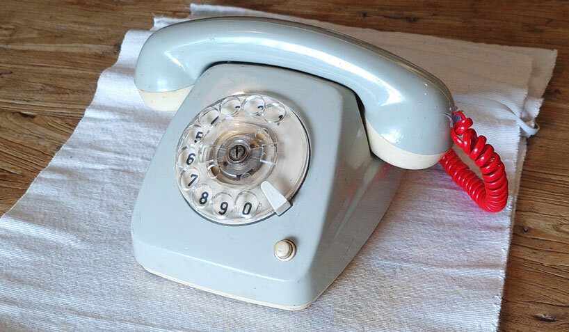 vintage rotary telephone transforms into analog-digital hybrid music player and AI voice chat