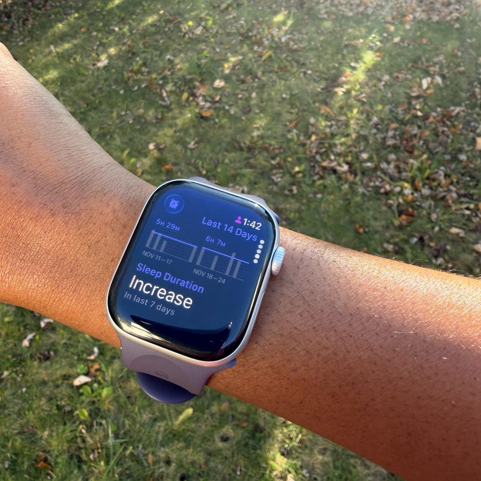 a woman wearing the apple watch series 11 while outdoors.