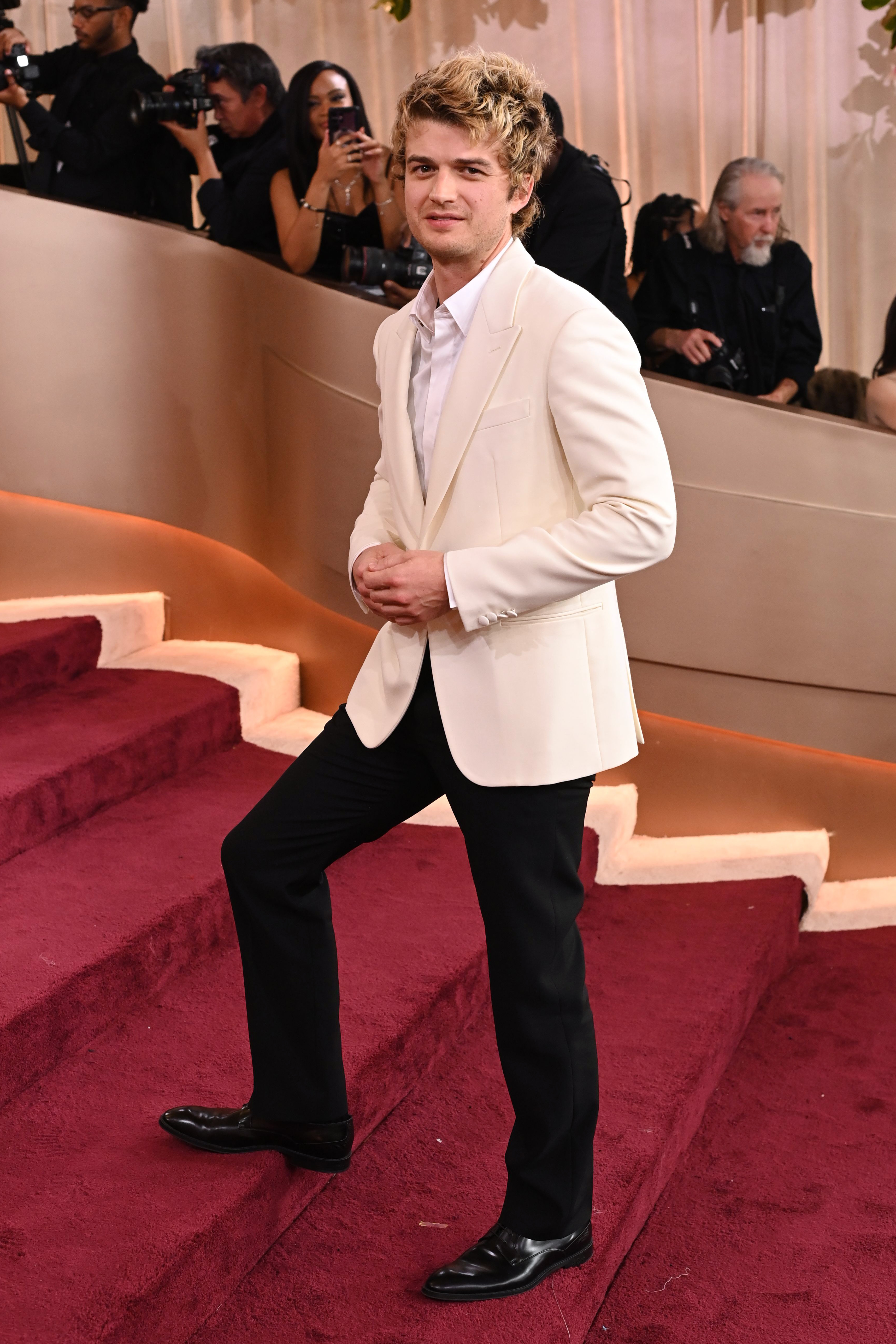 Joe Keery posing on a red carpet at the 83rd Annual Golden Globe Awards.
