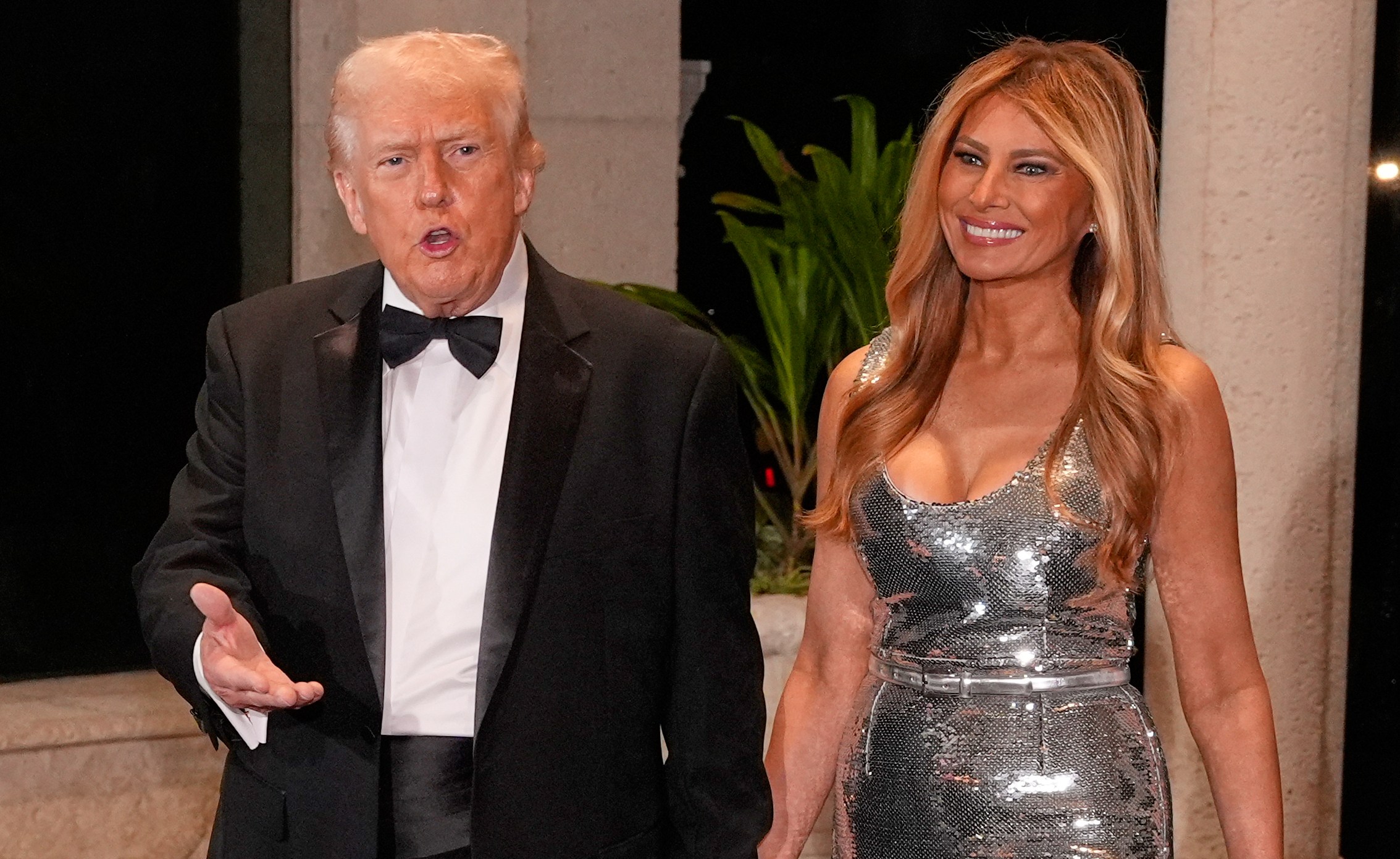 Donald and Melania Trump walking hand-in-hand to a New Year's Eve celebration.