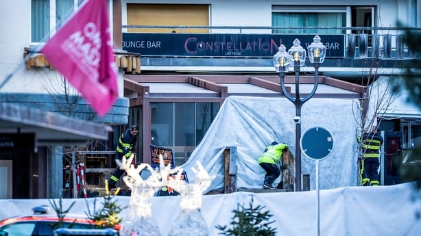 Rescuers and fire-fighters work at the site of an explosion