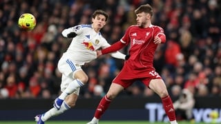 LIVERPOOL, ENGLAND - JANUARY 01: Conor Bradley of Liverpool battles for possession with Brenden Aaronson of Leeds United during the Premier League match between Liverpool and Leeds United at Anfield on January 01, 2026 in Liverpool, England. (Photo by Jan
