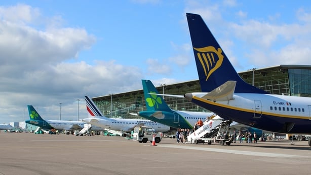 Image of the back of four planes parked on an airport apron 