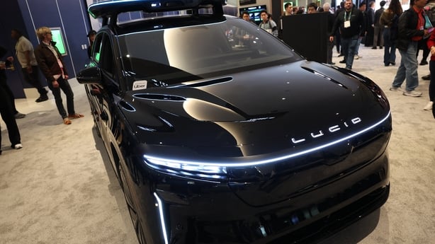 A black Uber Lucid robotaxi on display at CES 2026 
