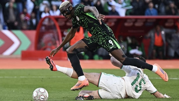 Nigeria's forward #09 Victor Osimhen and Algeria's defender #15 Rayan Ait-Nouri fights for the ball during the Africa Cup of Nations (CAN) quarter-final football match between Algeria and Nigeria at the Grand stadium in Marrakesh on January 10, 2026. (Photo by Paul ELLIS / AFP)