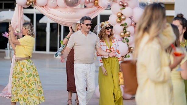 Jason O'Mara as Jerry and Justine Mitchell as Sandra arrive at the party in These Sacred Vows