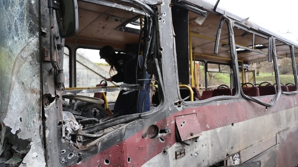 KHERSON, UKRAINE - JANUARY 30: A passenger bus hit by Russian shelling remains on a road at the site of the strike on January 30, 2026 in Kherson, Ukraine. The driver of a passenger bus was killed because of the shelling, and five more people received mine-explosive injuries. The Russian military co