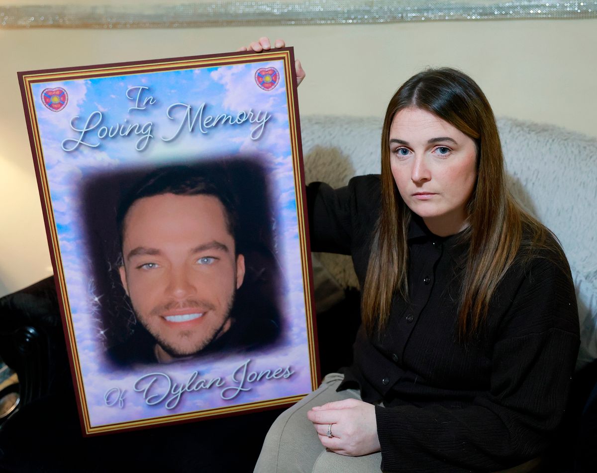 Cousin holding 'in loving memory' image