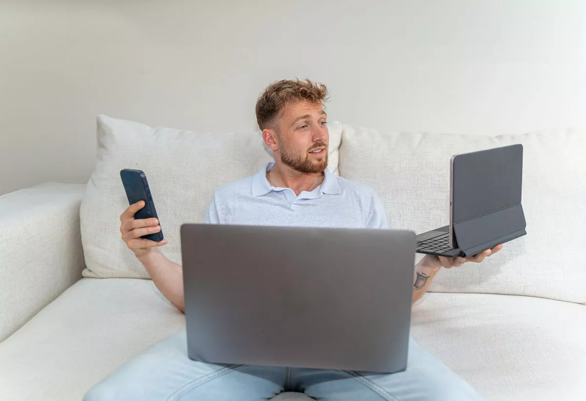 Man with phone and laptop