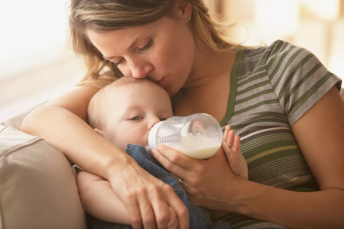 Mother feeding baby a bottle