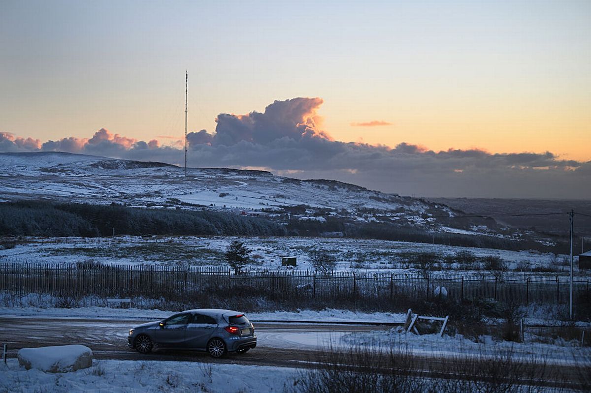 BELFAST, NORTHERN IRELAND - JANUARY 3: The sun rises over Divis mountain on January 3, 2026 in Belfast, United Kingdom. The Met Office is warning that snow showers will affect many parts of Northern Ireland over the weekend, bringing some disruption to travel.  (Photo by Charles McQuillan/Getty Images)