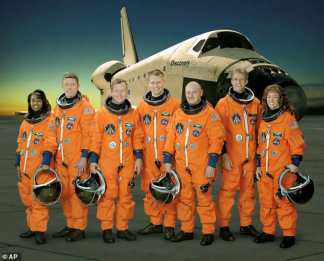Nowak (right) orbited the earth with a seven-member crew (pictured) aboard the space shuttle Discovery in 2006