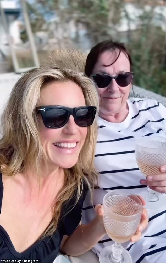 Elsewhere she enjoyed a glass of rose with her mother Janet while relaxing on holiday, wearing a frilly black swimsuit