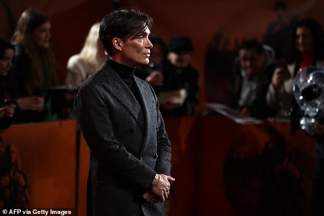 The actor opted for a sharp grey suit and a black polo neck as he posed on the black carpet