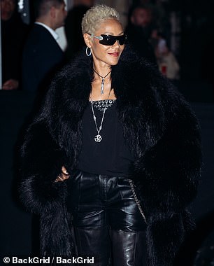 She layered the edgy look with a fuzzy black coat to stay warm in the chilly weather and slipped into open-toed heels