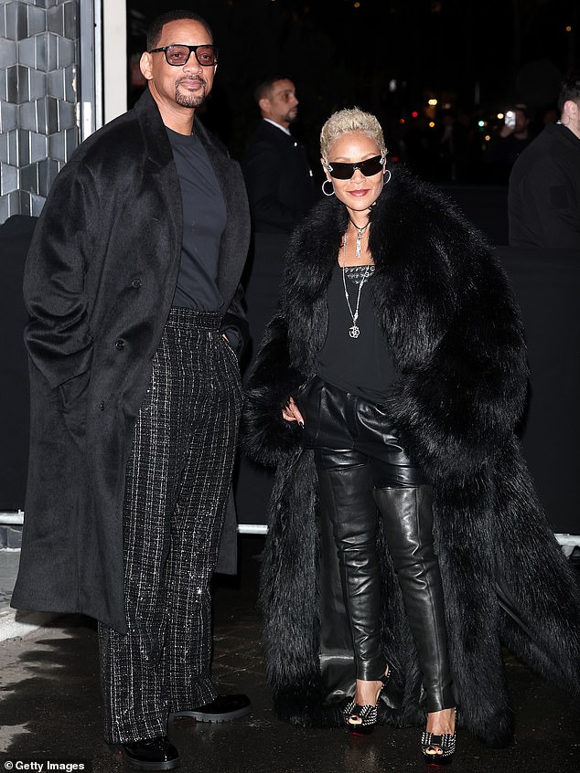 He layered the ensemble with a long black coat and slipped into a pair of sleek black shoes with chunky soles