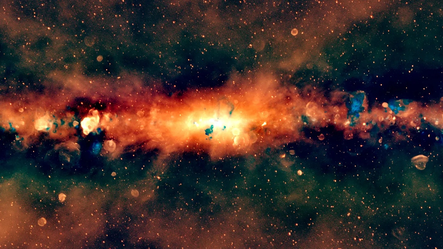 a radio-light, edge-on view of the Milky Way, artificially colored to show lower-frequency waves in red and higher-frequency waves in blue, shows a line of bright red and orange light with scattered blue bubbles