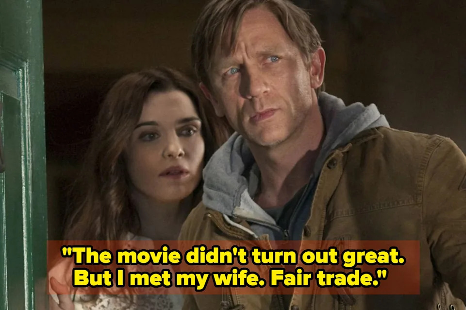 A man in a brown jacket and a woman in a white lace top stand in a doorway, looking intently outside