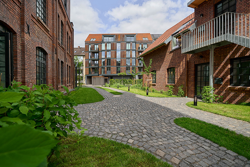 corten steel extends former laundry complex’s brick buildings in kassel