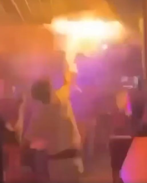 A man attempts to tackle the fire, moments before it spread. Video grab