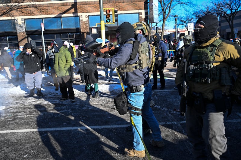 Fedearl agents respond as demonstators gather near the site of where a man was shot by federal agents earlier on Saturday in Minneapolis. Photograph: Roberto Schmidt/AFP via Getty