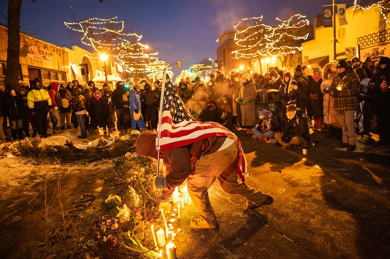 Demonstrators place candles and flowers at a makeshift memorial at the site where Alex Jeffrey Pretti, a registered nurse was shot and killed by ICE agents in Minneapolis earlier that morning, on Saturday, Jan. 24, 2026. (Photo by David Guttenfelder/The New York Times)