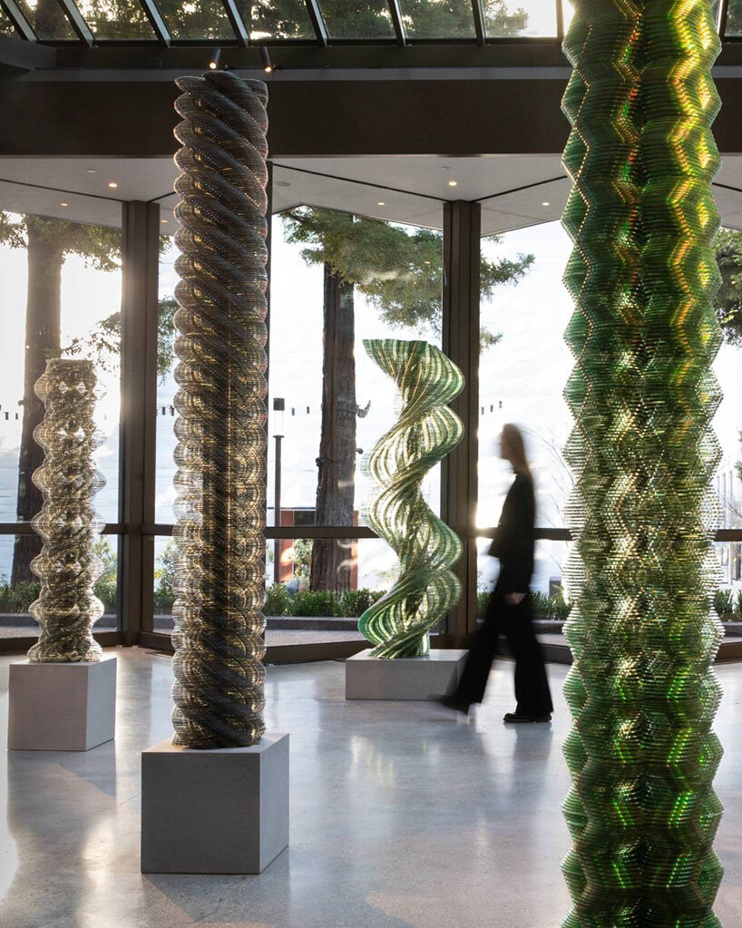 thousands of recycled CDs form reflective vertical sculptures in tara donovan's stratagems