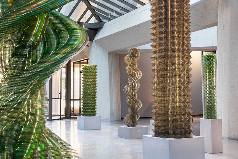 thousands of recycled CDs form reflective vertical sculptures in tara donovan's stratagems