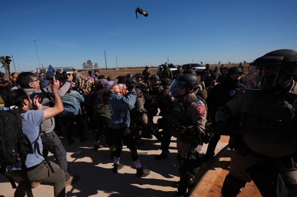 A canister of pepper spray launched by Texas troopers flies towards protesters outside the South Texas Family Residential Center detention facility where Liam Ramos and his father are being detained in Dilley, Texas, Wednesday, Jan. 28, 2026. (AP Photo/Eric Gay, File)