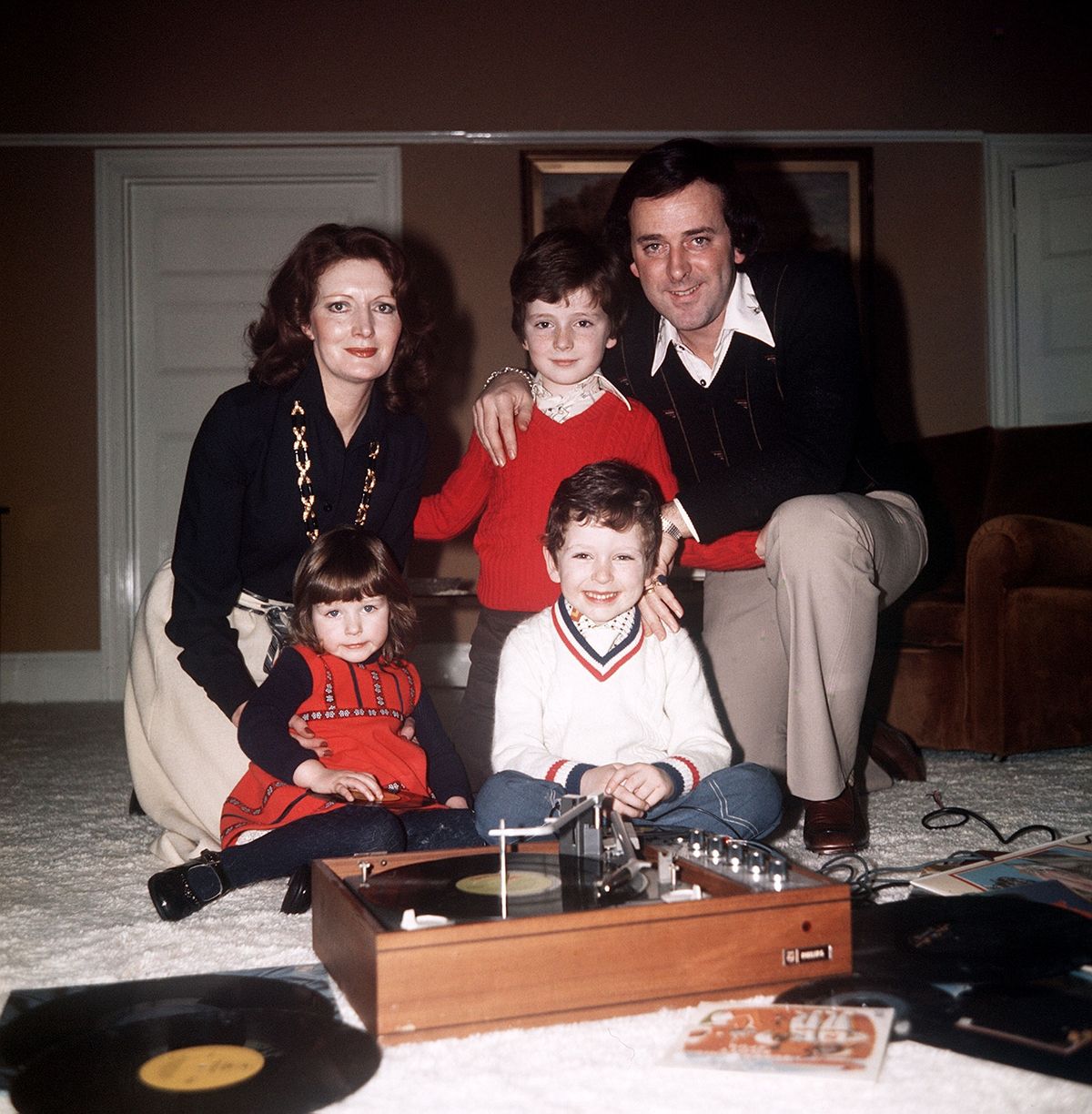 Sir Terry Wogan posing at home with his wife Helen and their three children