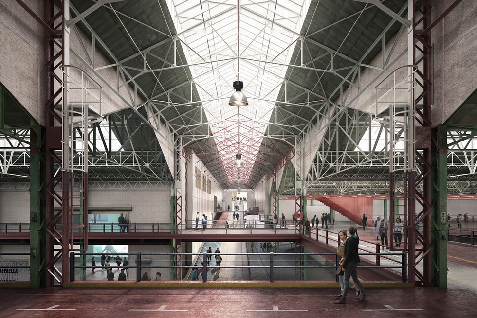 Large indoor space with high ceilings and exposed structure, occupied by people.