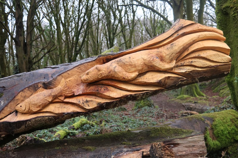 A wooden otter chases a wooden fish in this sculpture carved from a fallen tree in Barna Woods. Photograph: Ronan McGreevy 