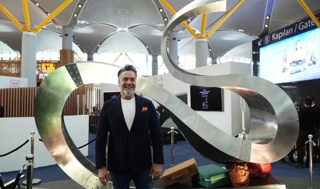 Beyazıt Öztürk poses with his artwork “Free Conveyor” from the “Things” exhibition at Istanbul Airport, Istanbul, Türkiye, Jan. 22, 2026. (Photo by Funda Karayel)