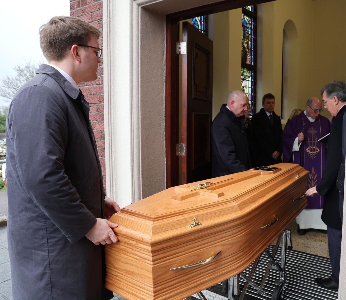  Fr Michael Keohane blessing the coffin bearing the remains of Seán Ó Sé on its arrival into Our Lady of Lourdes Church, Ballinlough Rd, Cork. Picture: Jim Coughlan