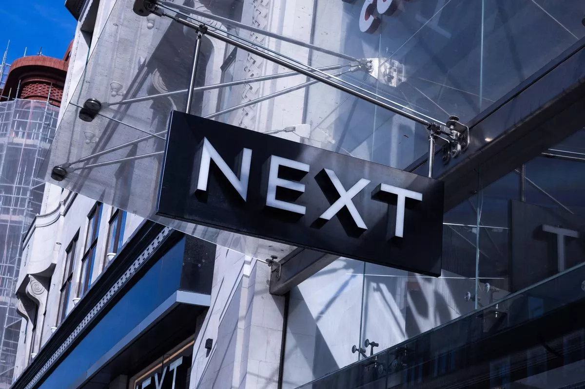 A sign above the entrance to a Next Plc store on Oxford Street in London, UK, on Thursday, May 1, 2025. Next will release their first-quarter trading statement on Thursday, May 8. Photographer: Chris Ratcliffe/Bloomberg via Getty Images