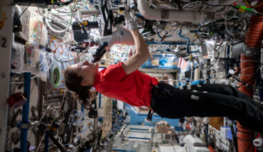 A woman conducts a research experiment aboard the International Space Station.