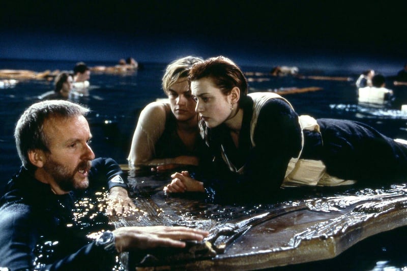 Titanic: director James Cameron with Leonardo DiCaprio and Kate Winslet during the filming of the 1997 film's floating-door scene. Photograph: 20th Century Fox