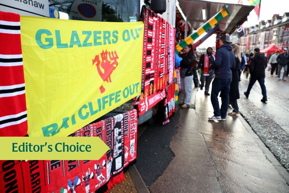 Manchester United scarfs and a banner in protest against owners Jim Ratcliffe and the Glazer family outside the stadium.