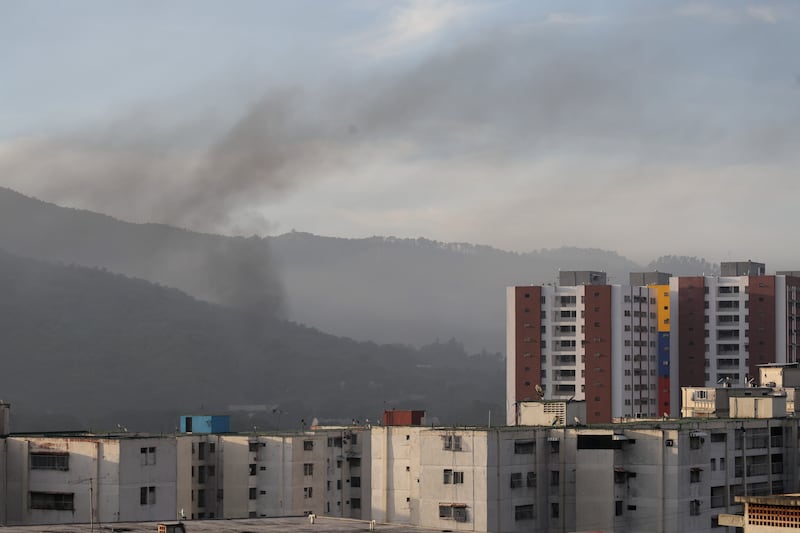 Smoke is seen over buildings after explosions and low-flying aircraft were heard on Saturday in Caracas, Venezuela. Photograph: Jesus Vargas/Getty Images